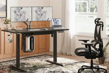 A modern standing desk with dual monitors