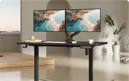 A sleek, modern standing desk with dual monitors displaying a beach scene