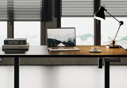 a serene workspace featuring a laptop showcasing a mountainous landscape