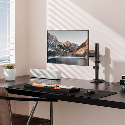 HUANUO Single Monitor Mount in modern workspace with mountain scenery on screen